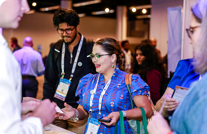 An attendee picking up a ticket at IFMA’s Facility Fusion 2026, highlighting new formats, expanded expo access, and fresh event experiences.